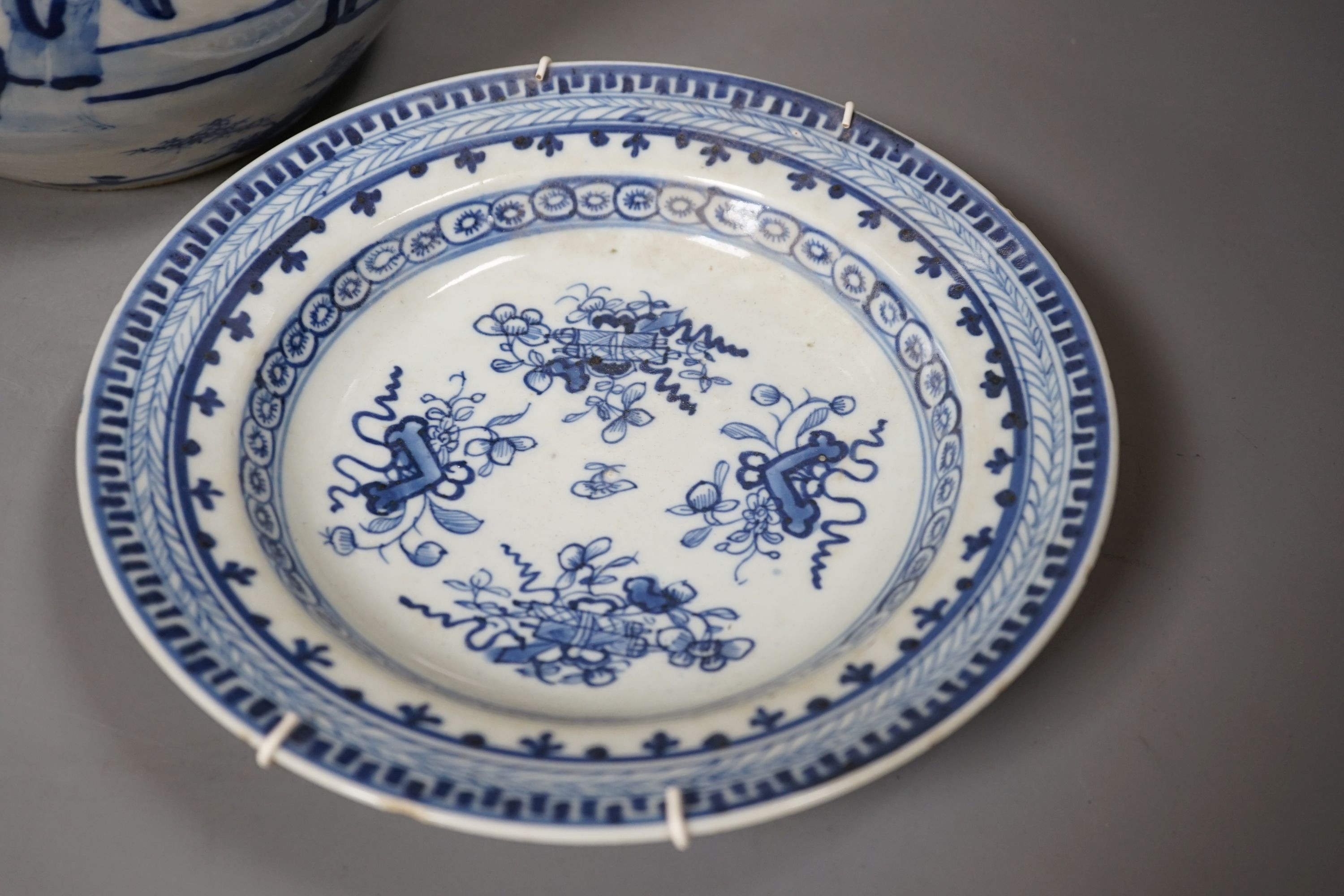A 19th century Chinese blue and white jardiniere and a similar plate, 20 cms high.